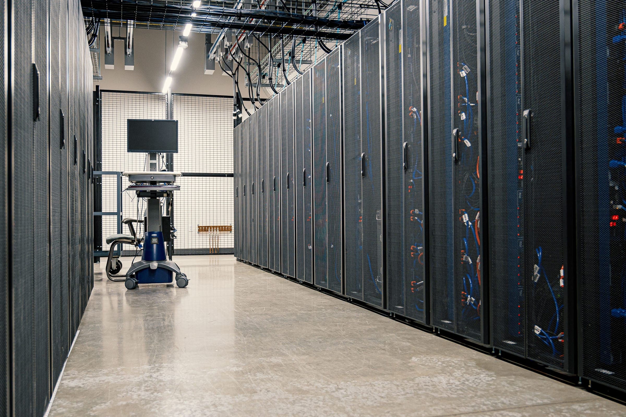 Pasillo de un centro de datos con hileras de racks de servidores